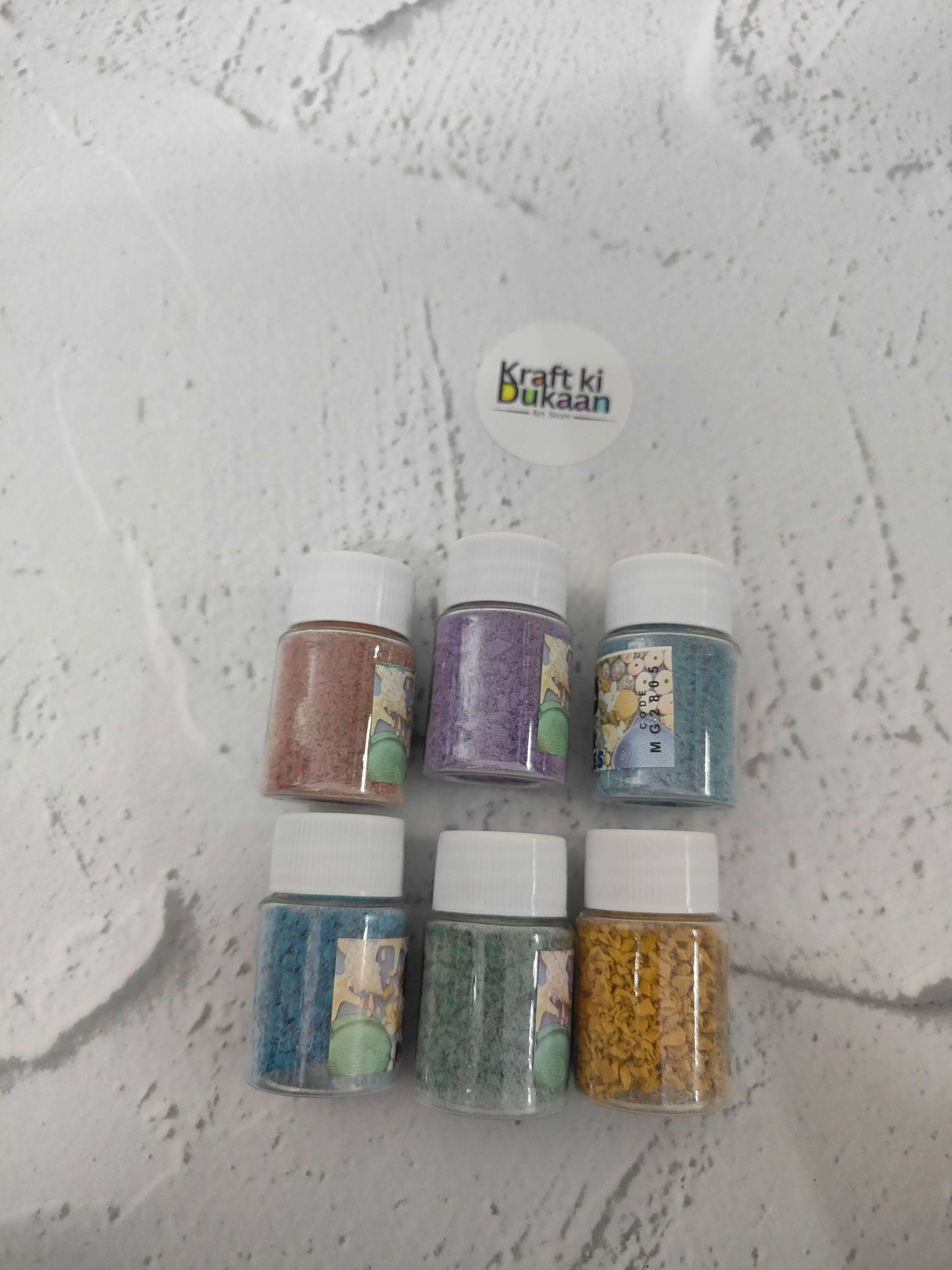 Rubber particles pack of 6: six bottles showing teal, purple, blue, green, yellow shades