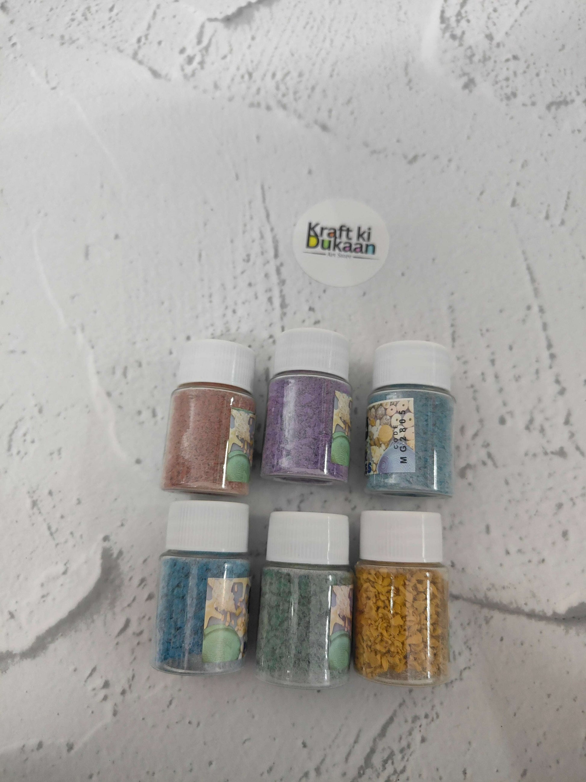 Rubber particles pack of 6: six bottles showing teal, purple, blue, green, yellow shades