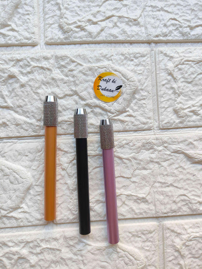 Pencil extender set with orange, black, and pink bodies and textured metal tip