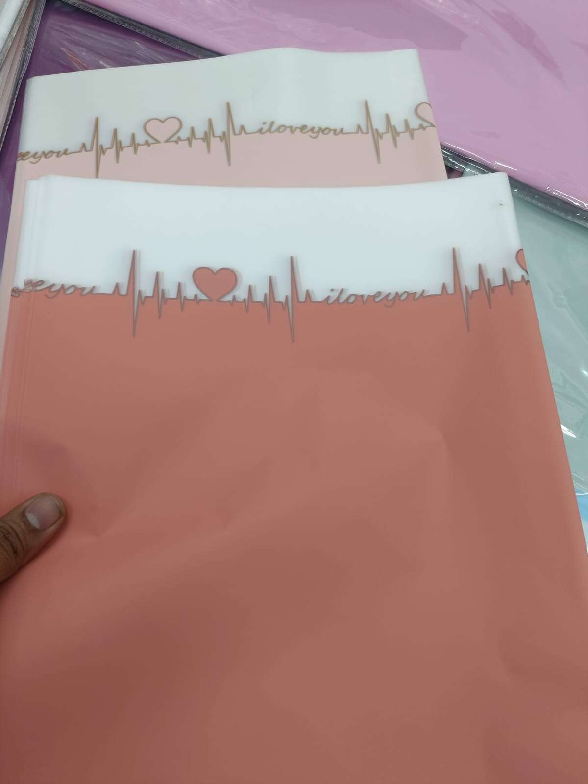 Orange wrapping paper sheet with gold ECG line, heart and 'iloveyou' text