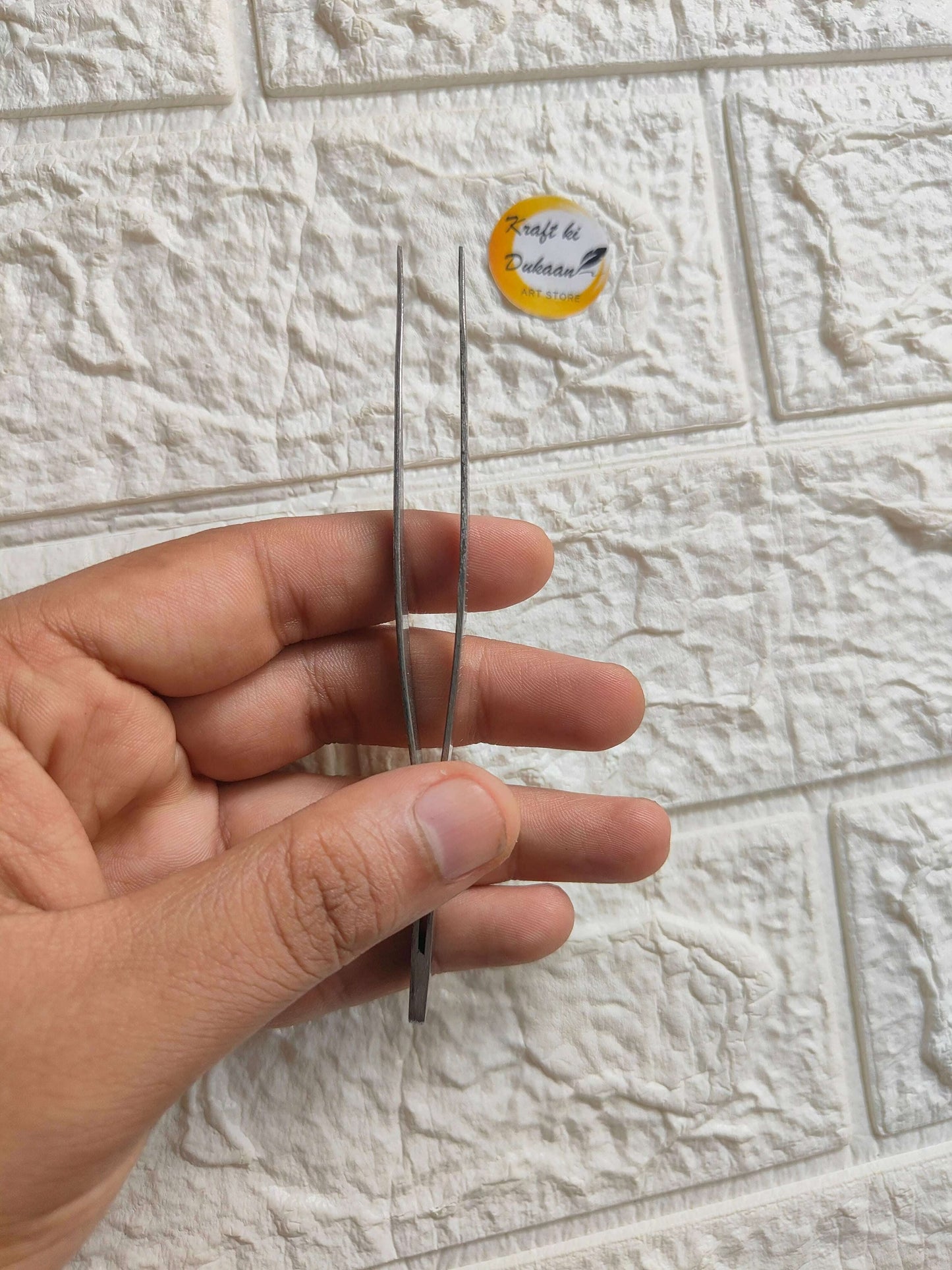 precision-craft-tweezers-held-in-hand-stainless-steel