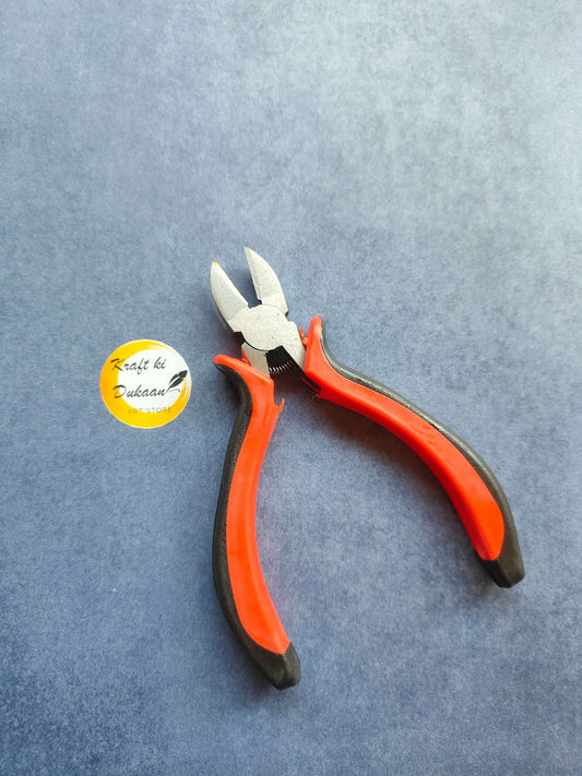 Red and orange insulated pliers with black grips and pointed cutting tips