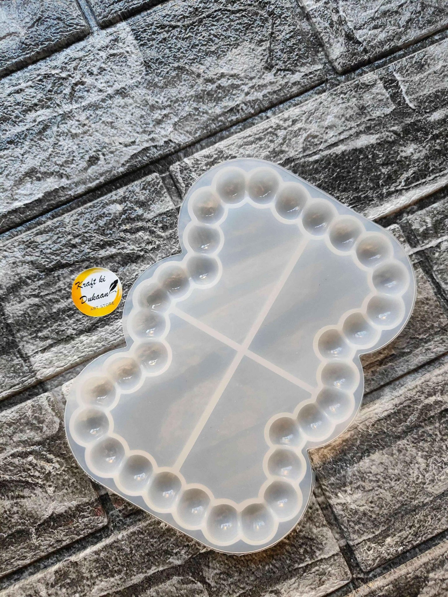 Rectangle bubble dish mould with rounded edge bumps and three divider lines, translucent white