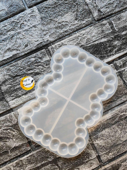 Rectangle bubble dish mould with rounded edge bumps and three divider lines, translucent white