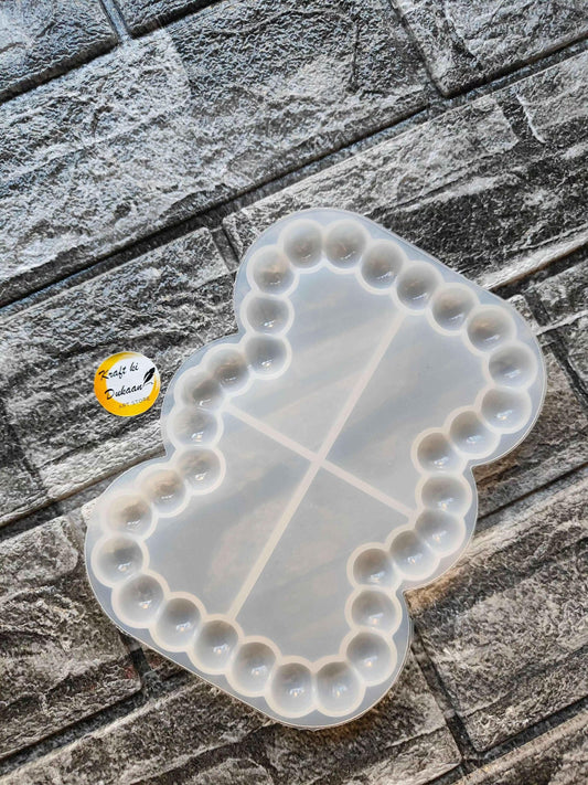 Rectangle bubble dish mould with rounded edge bumps and three divider lines, translucent white