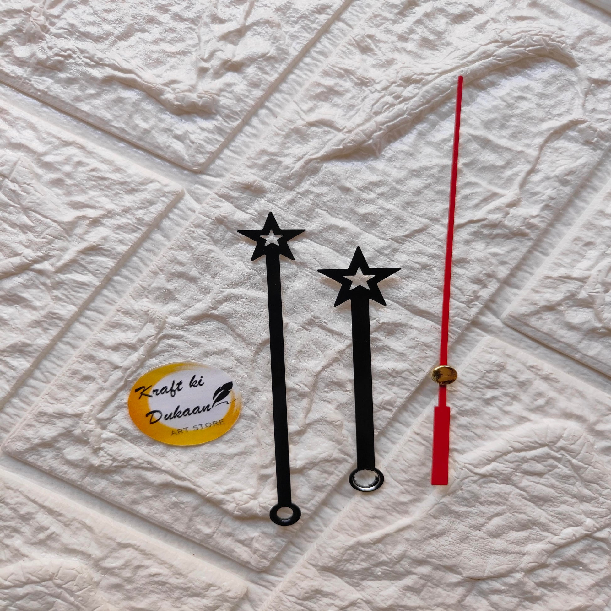 Set of red and black clock hands with star designs for DIY clock projects