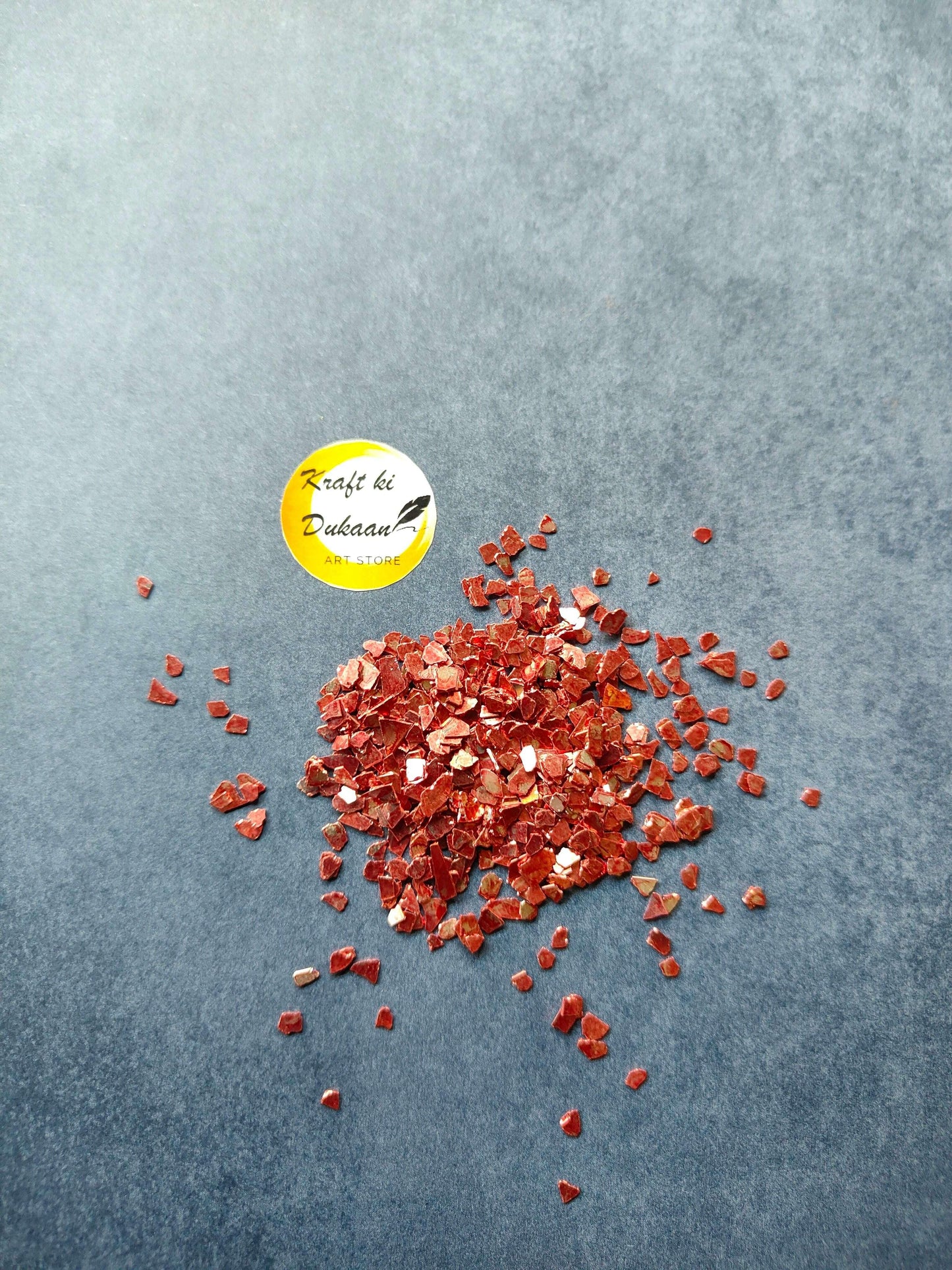 Red crystal chips pile, small shiny red flakes
