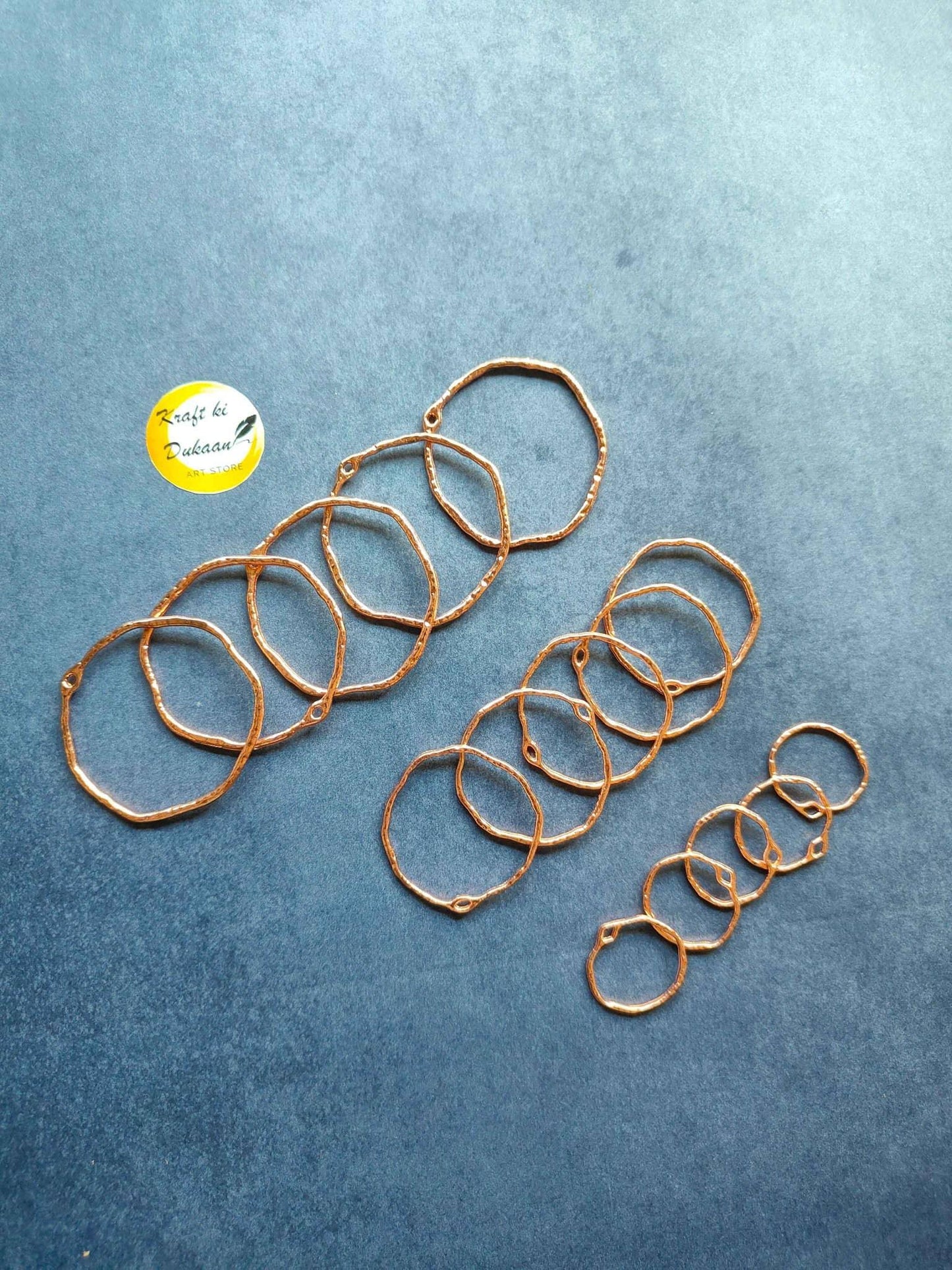 Rose gold-tone round bezel settings, several ring frames
