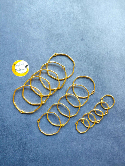 Gold-tone round bezel settings, several stacked ring frames