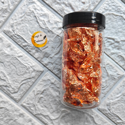 Kraft ki Dukaan resin art foil flakes in a clear jar with vibrant orange flakes for artistic projects