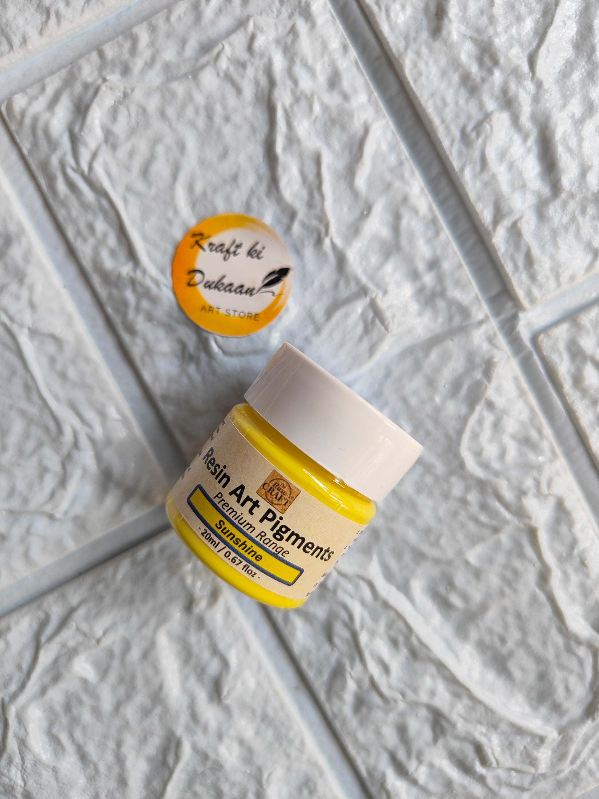 Opaque pigment for resin art in yellow jar by Kraft ki Dukaan with a branded button