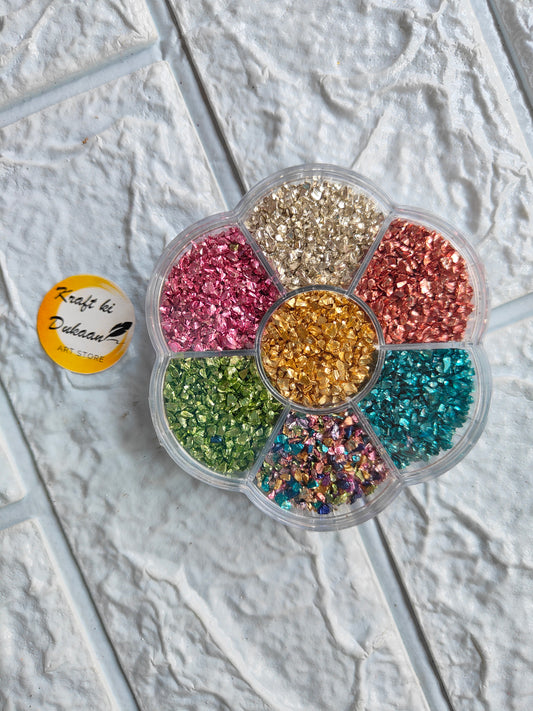 Colorful glitter assortment in a flower-shaped container for resin art stone box projects