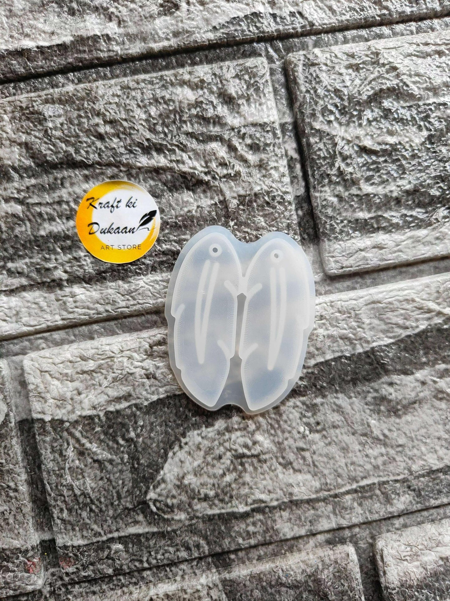 Earring Mould A2 — open translucent butterfly-shaped silicone mold with embossed details