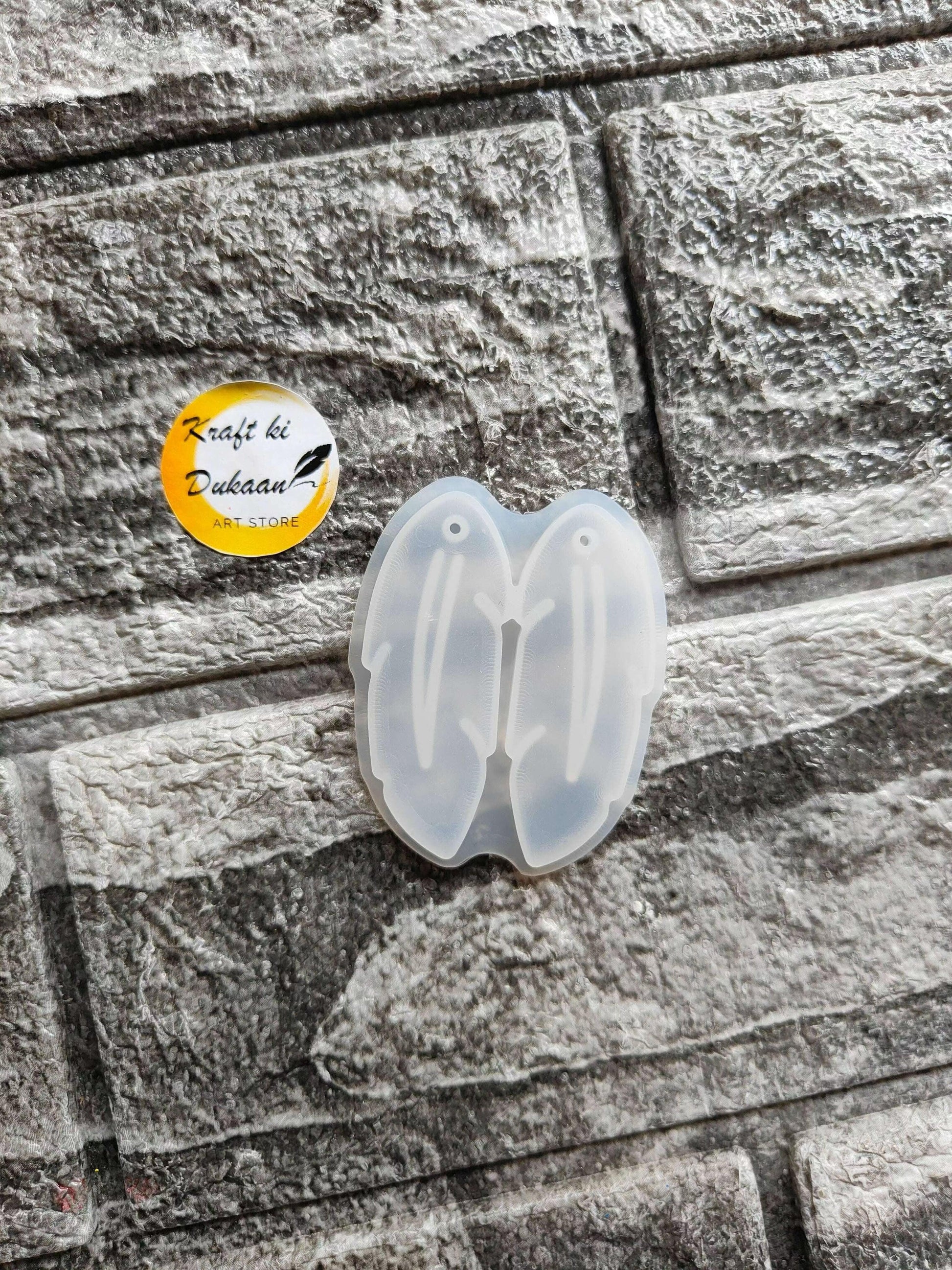Earring Mould A2 — open translucent butterfly-shaped silicone mold with embossed details