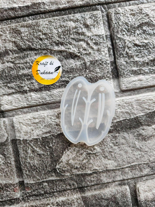 Earring Mould A2 — translucent white butterfly-shaped silicone mold with carved studs