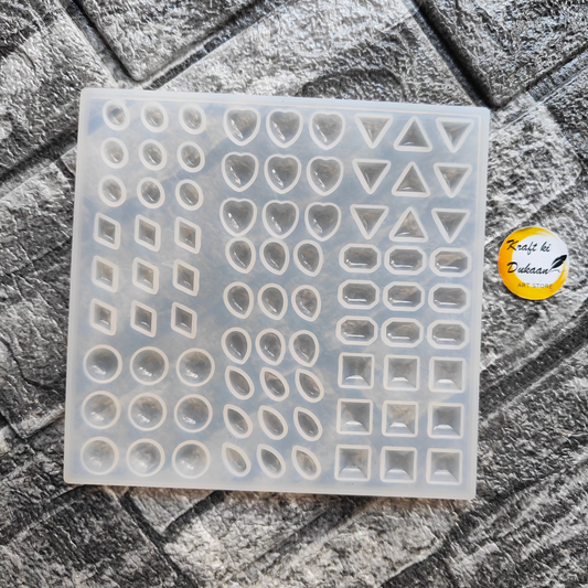 Kraft ki Dukaan resin jewelry making mold with various shapes including hearts, triangles, and circles