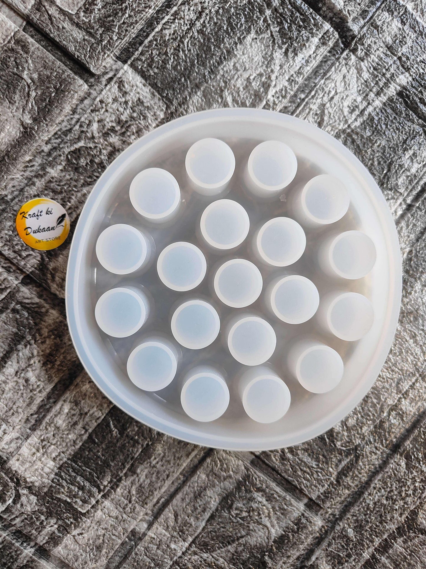 Round lipstick holder mould tray with multiple circular wells and pale blue inserts