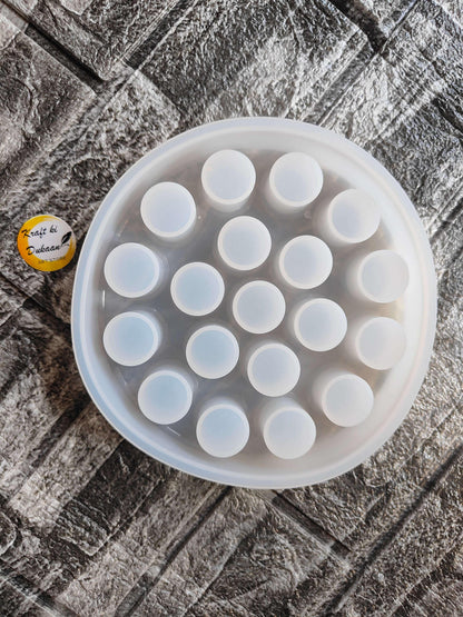 Round lipstick holder mould tray with multiple circular wells and pale blue inserts