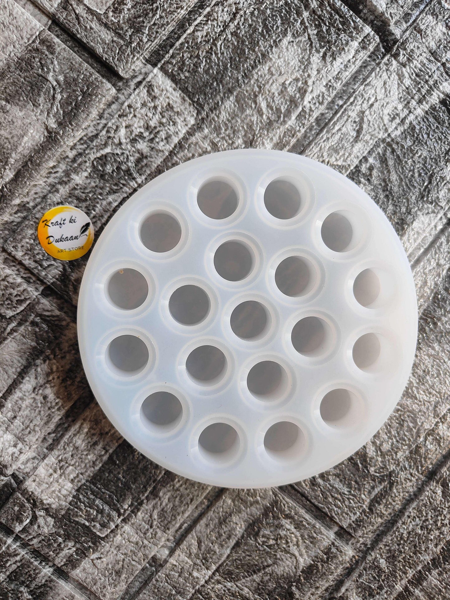 Round lipstick holder mould tray with multiple circular wells, shown from above