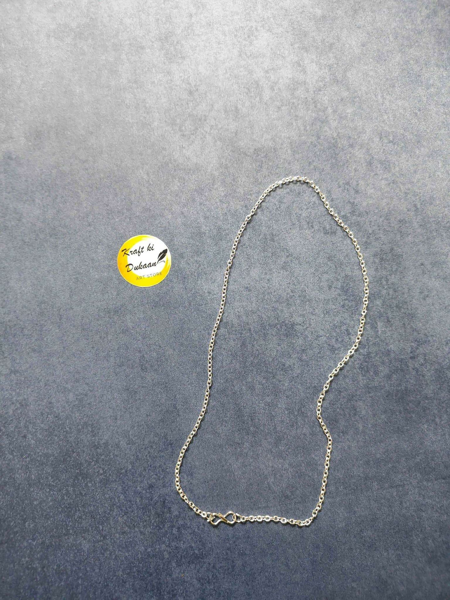 Silver short chain necklace, teardrop-style chain with clasp detail laid out