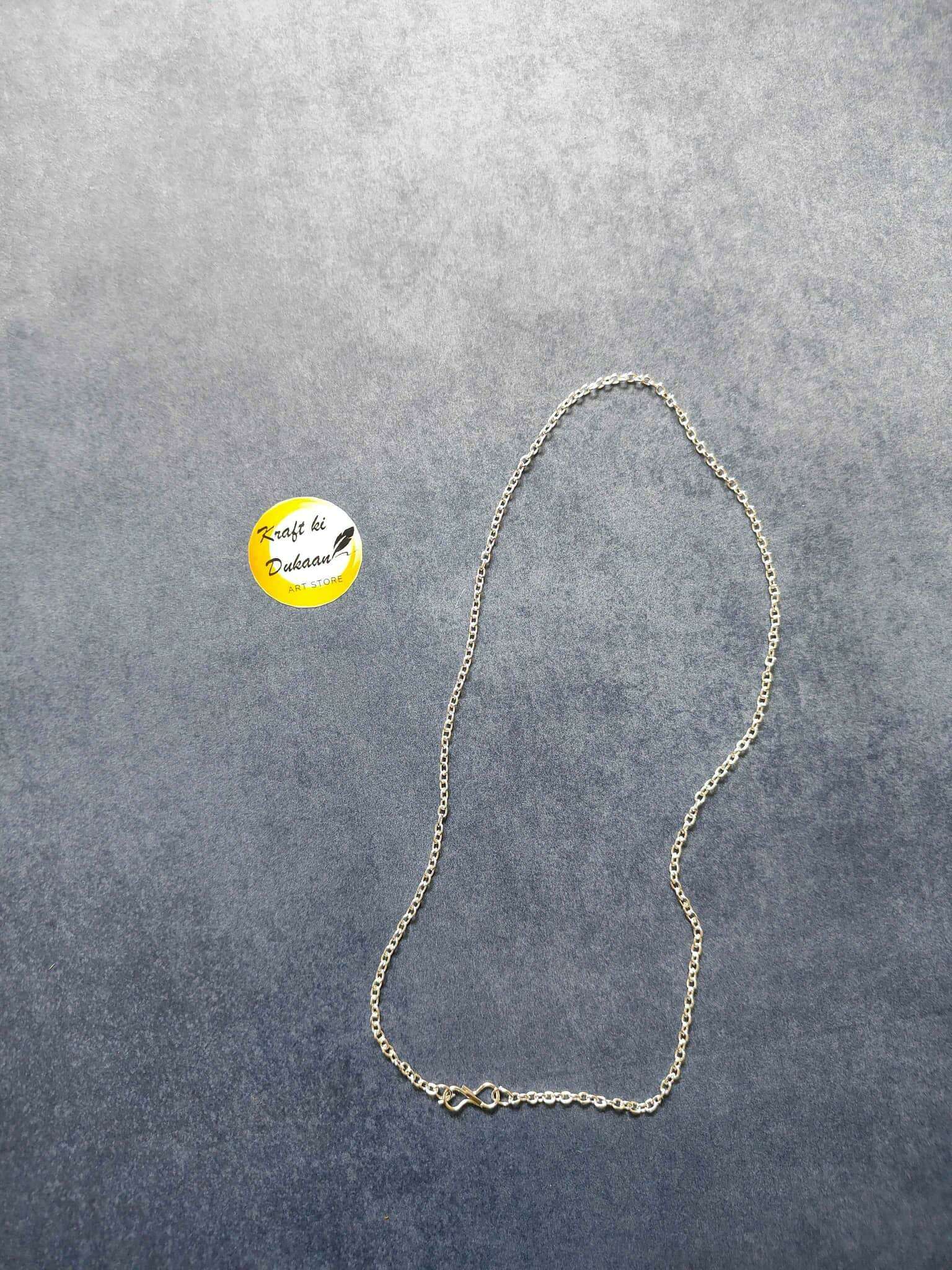Silver short chain necklace, teardrop-style chain with clasp detail laid out