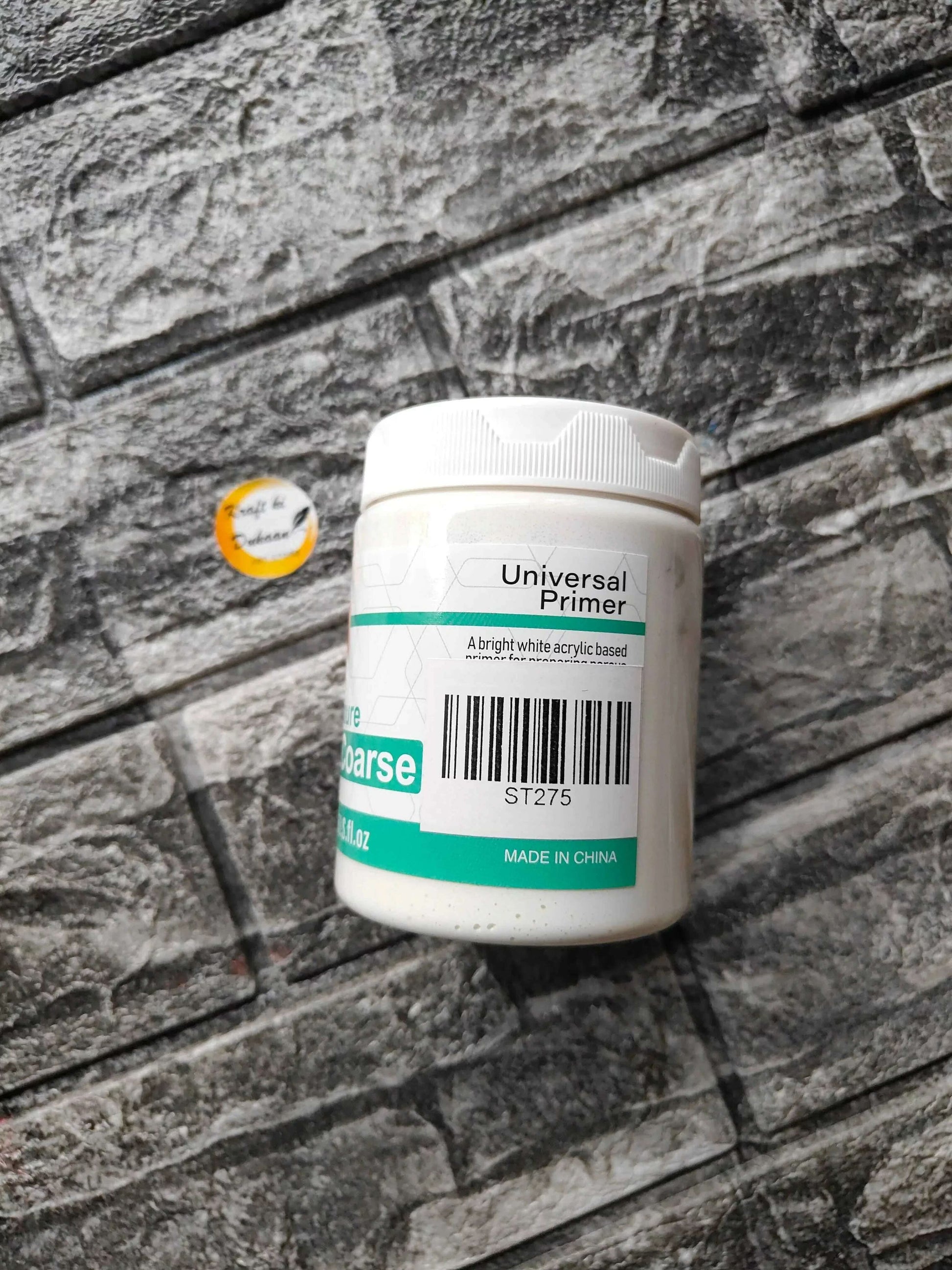 White jar with ridged cap, back label shows “Universal Primer” and barcode