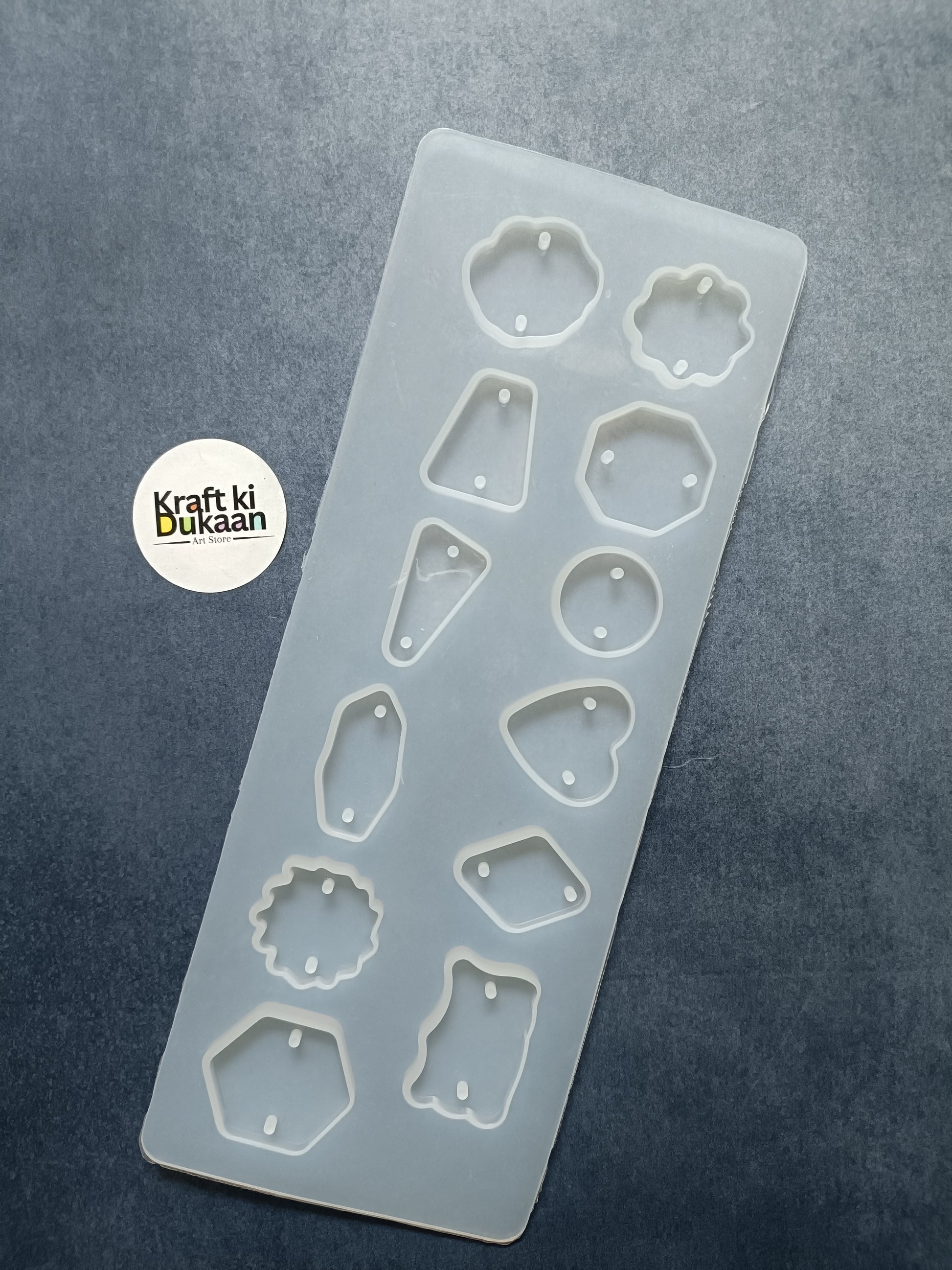 12-cavity rakhi mould with assorted embossed shapes on light blue tray