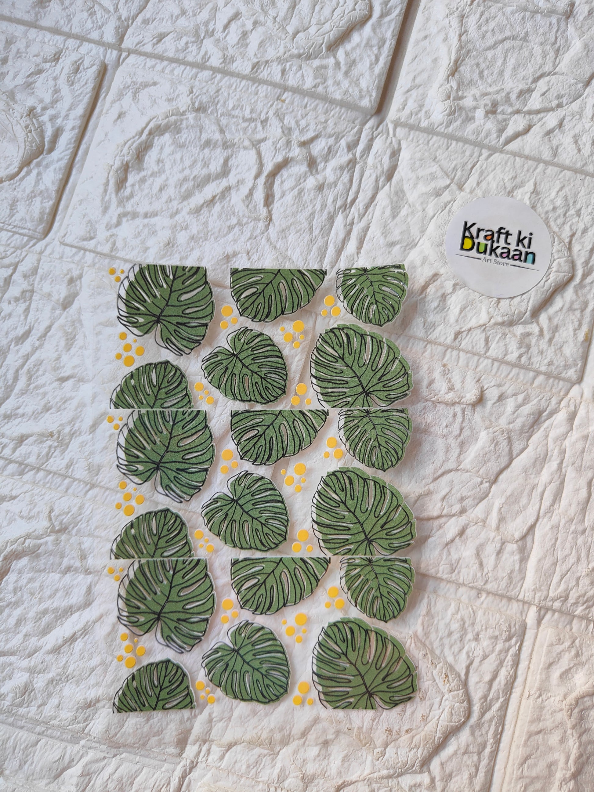 UV DTF peel-off sticker sheet with green monstera leaves and yellow dots, Kraft ki Dukaan