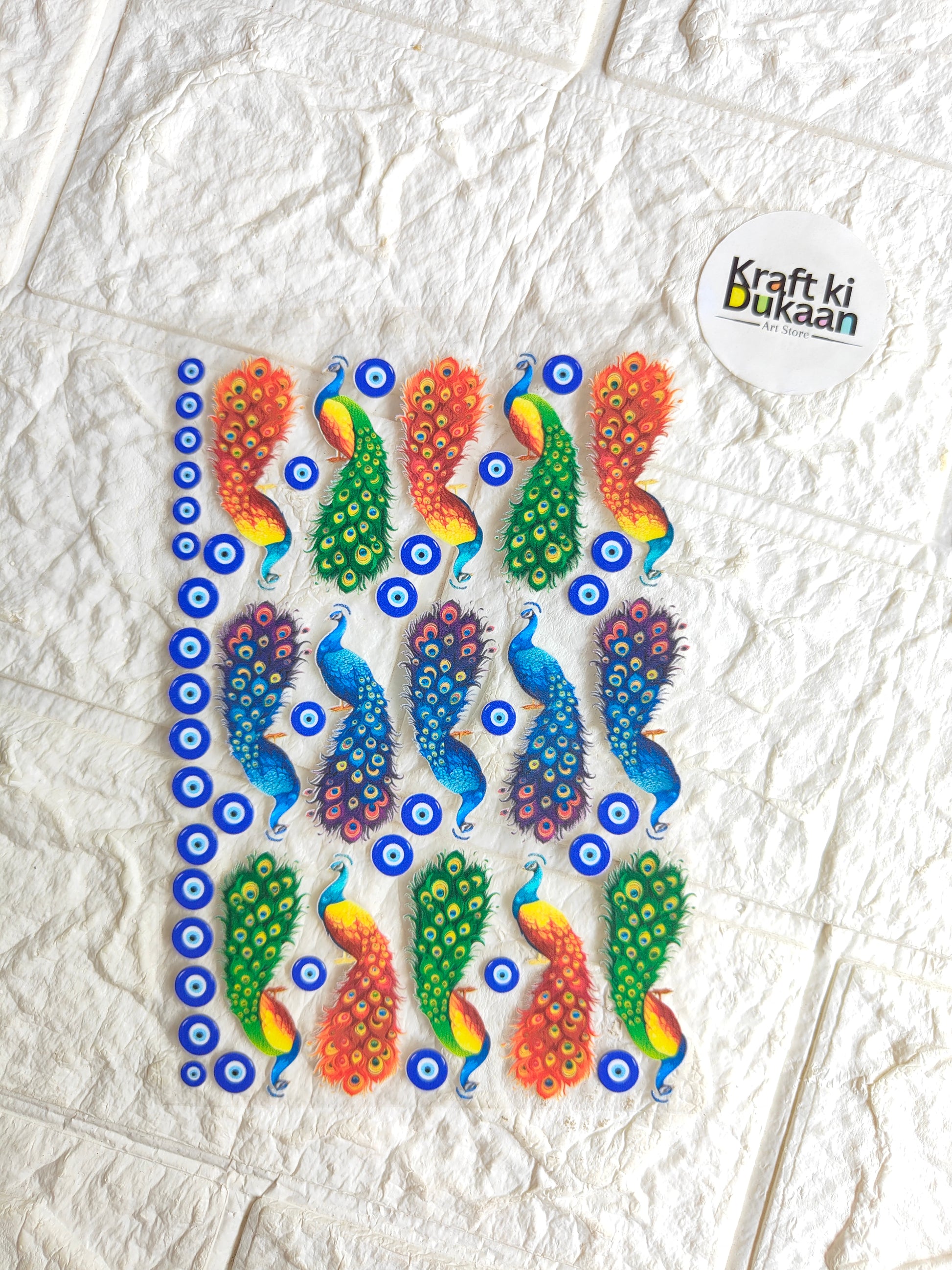 UV DTF peel-off sticker sheet with colorful fish and eye-circle pattern, Kraft ki Dukaan logo