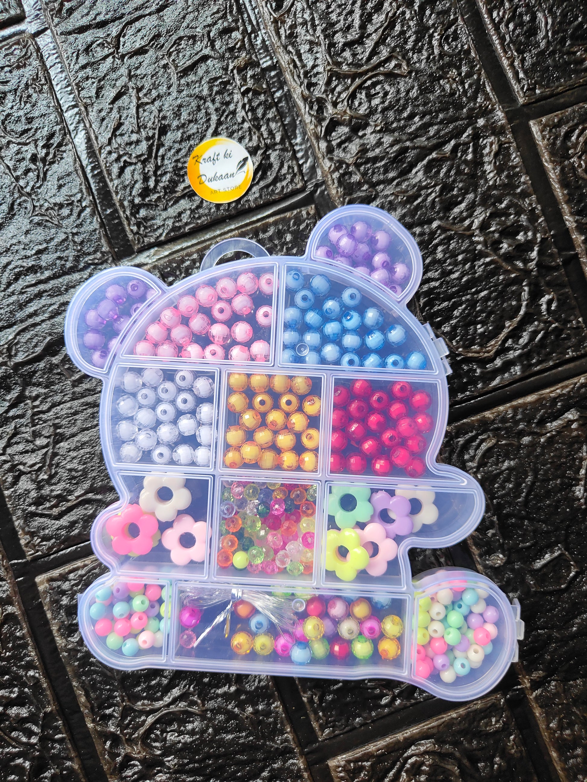 Heart-shaped organizer tray filled with multicolor round beads for DIY bracelet making