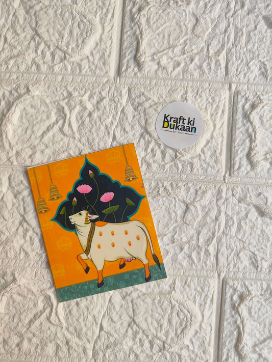 Mini colour sticker sheet with illustrated black-and-white cow on orange background