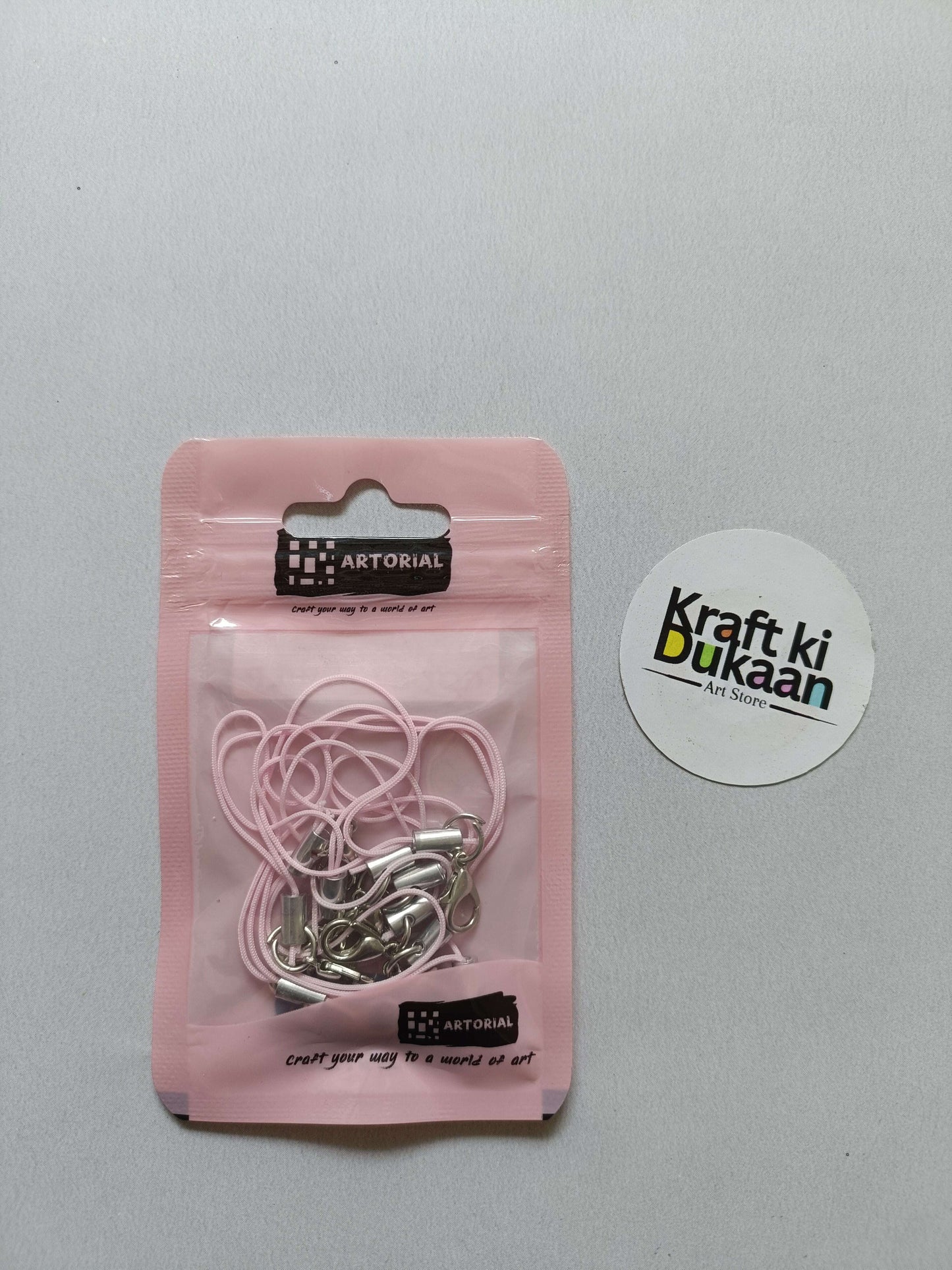Light pink rope keychain set with silver lobster clasps, packaged in pouch