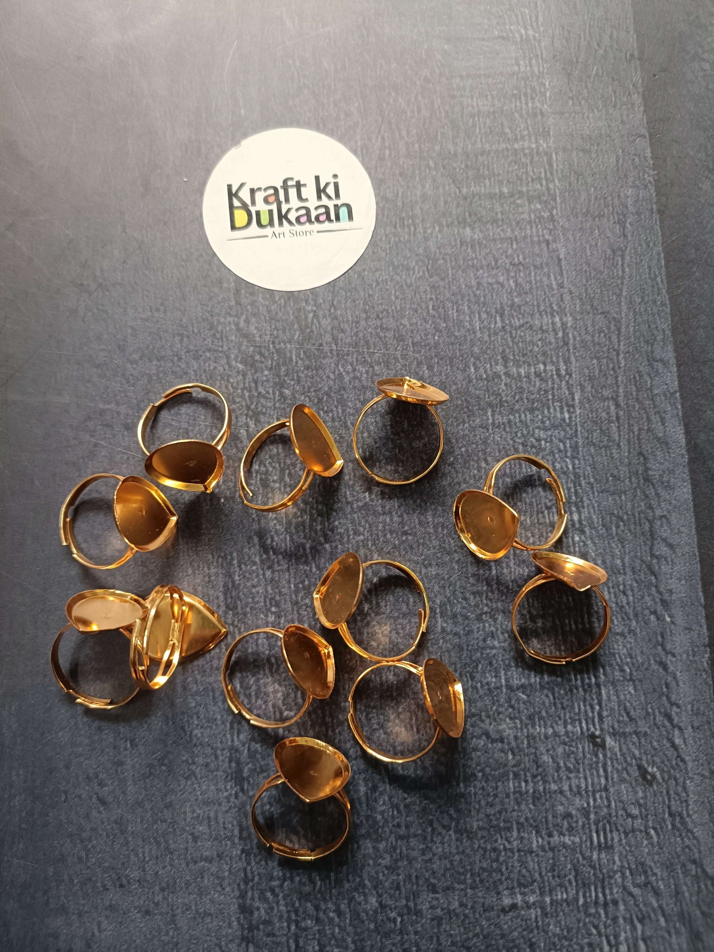 Gold-tone ring bases, multiple open bands with oval and round bezel tops
