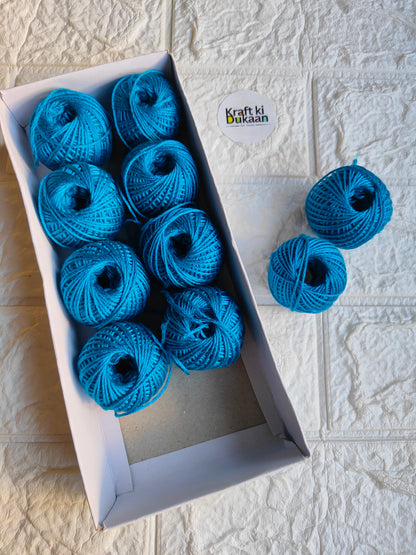Rakhi thread roll with blue yarn balls in an open box and one loose ball