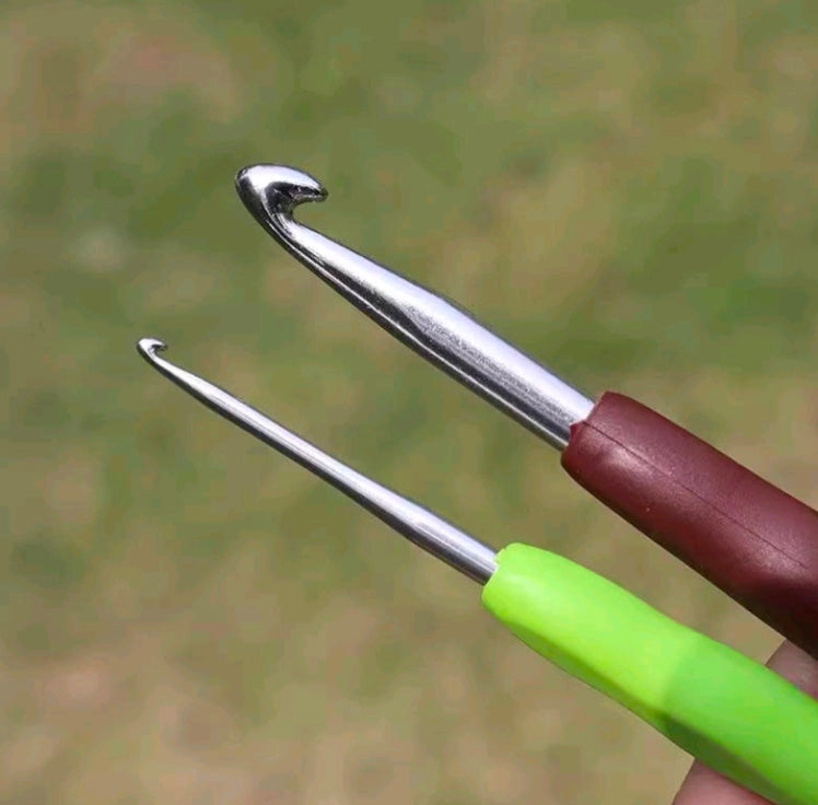 Set of two knitting needles with silver tips and green and burgundy handles