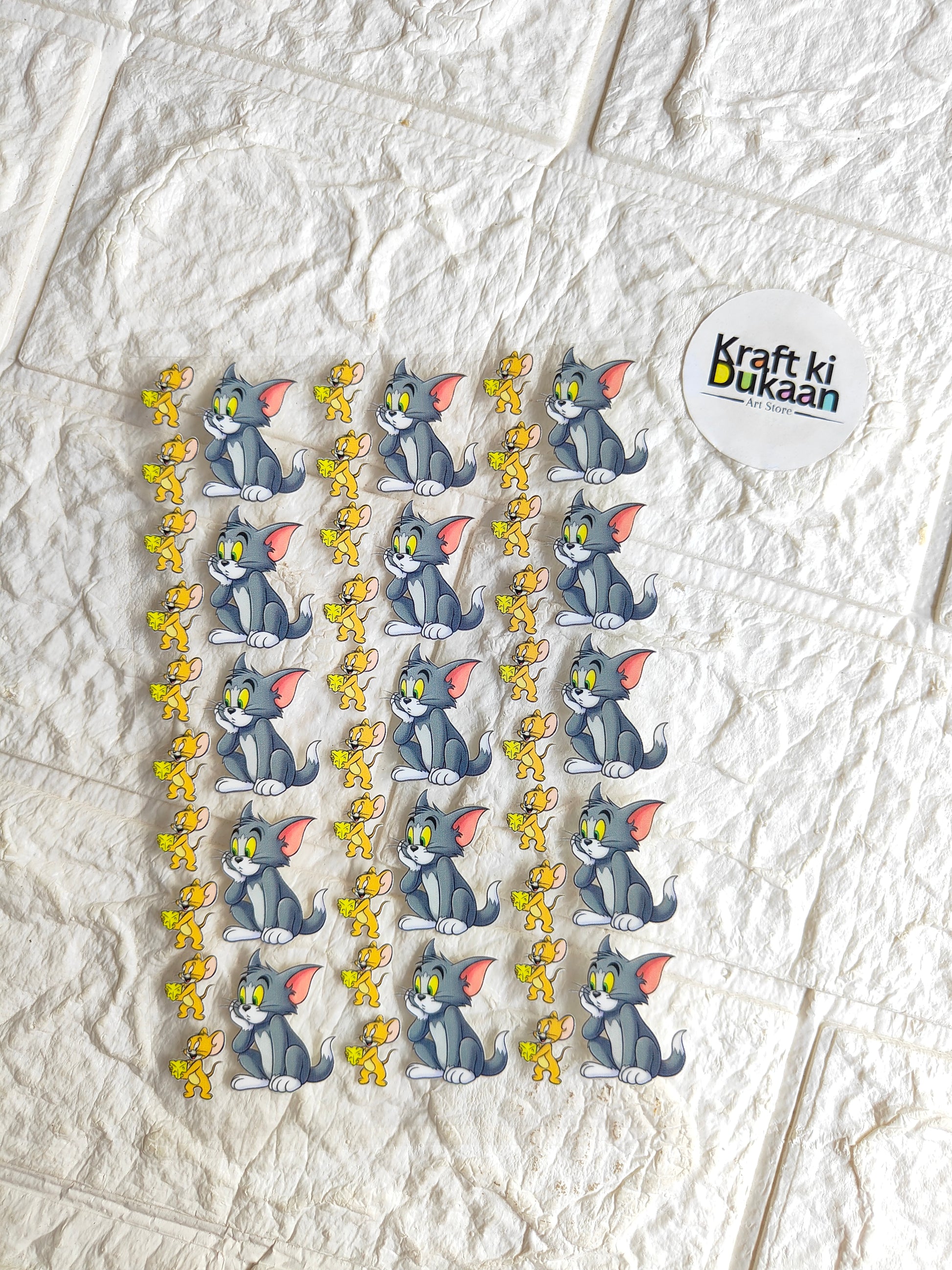 UV DTF peel-off sticker sheet with blue cartoon cat faces and yellow star accents