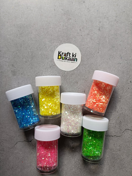 Assorted glitter jars in blue, yellow, silver, red, pink, and green