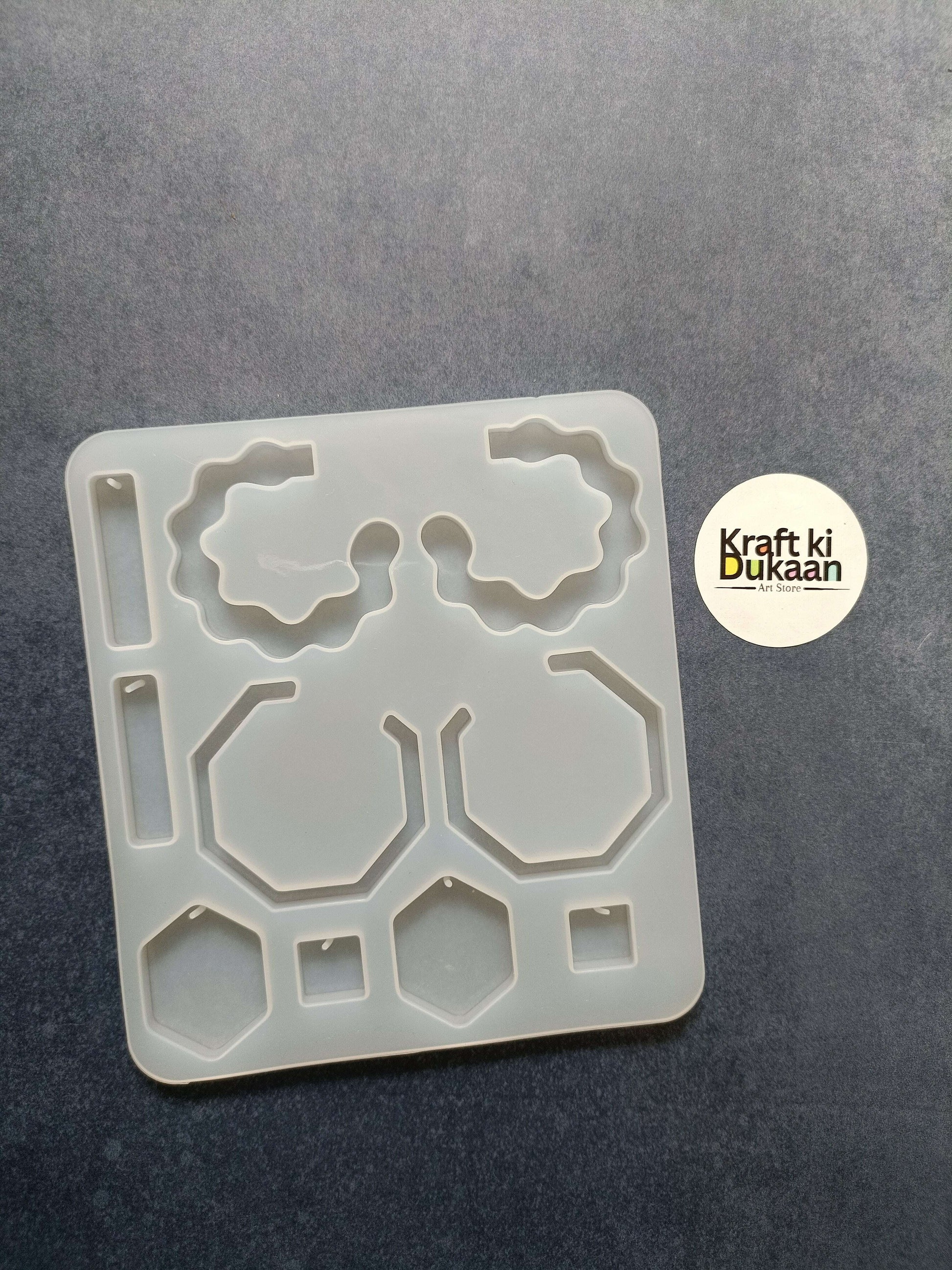 10-cavity jewelry mould, white plastic, geometric cavity shapes