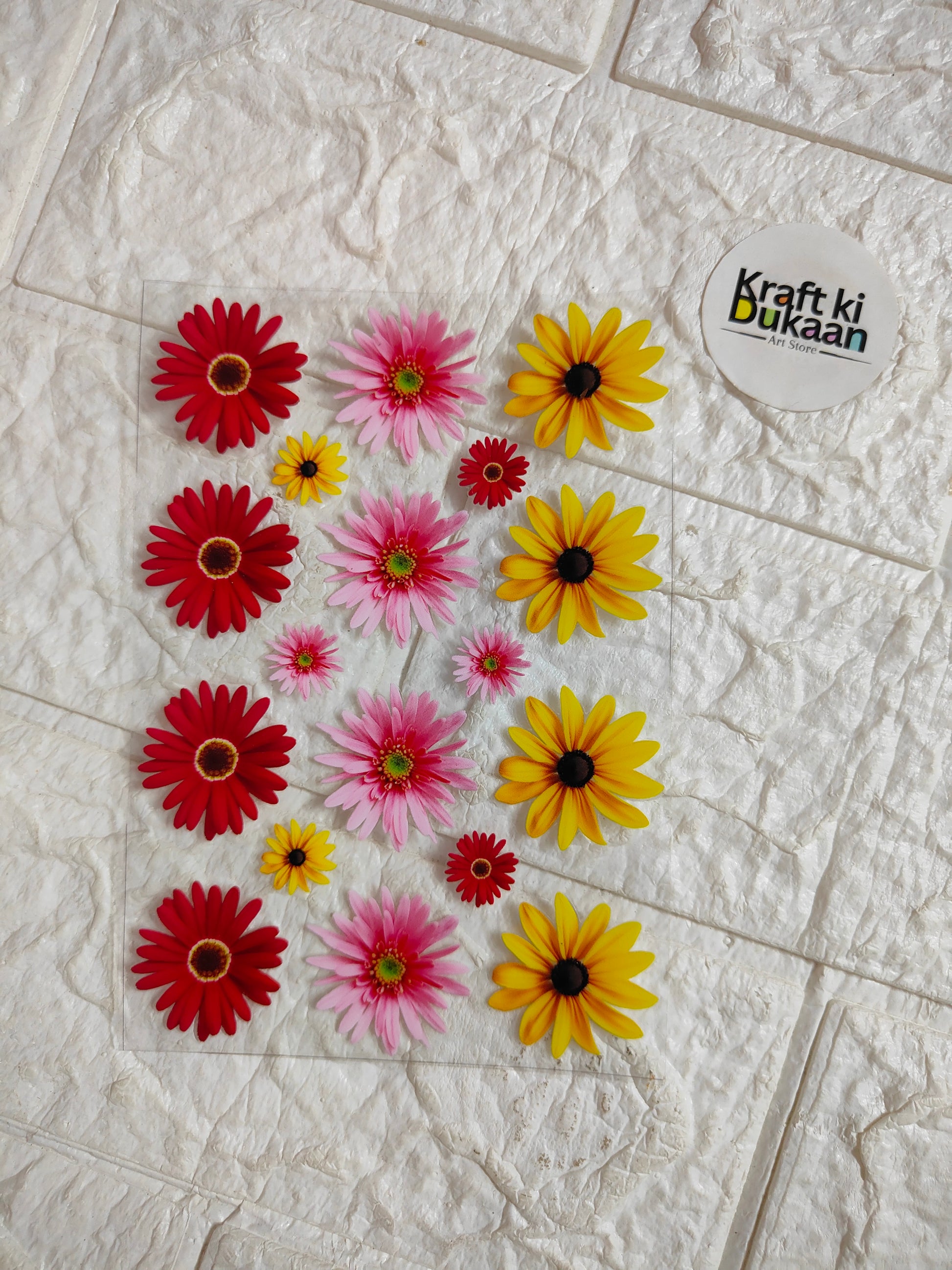 UV DTF peel-off sticker sheet with red, pink, and yellow daisy flowers