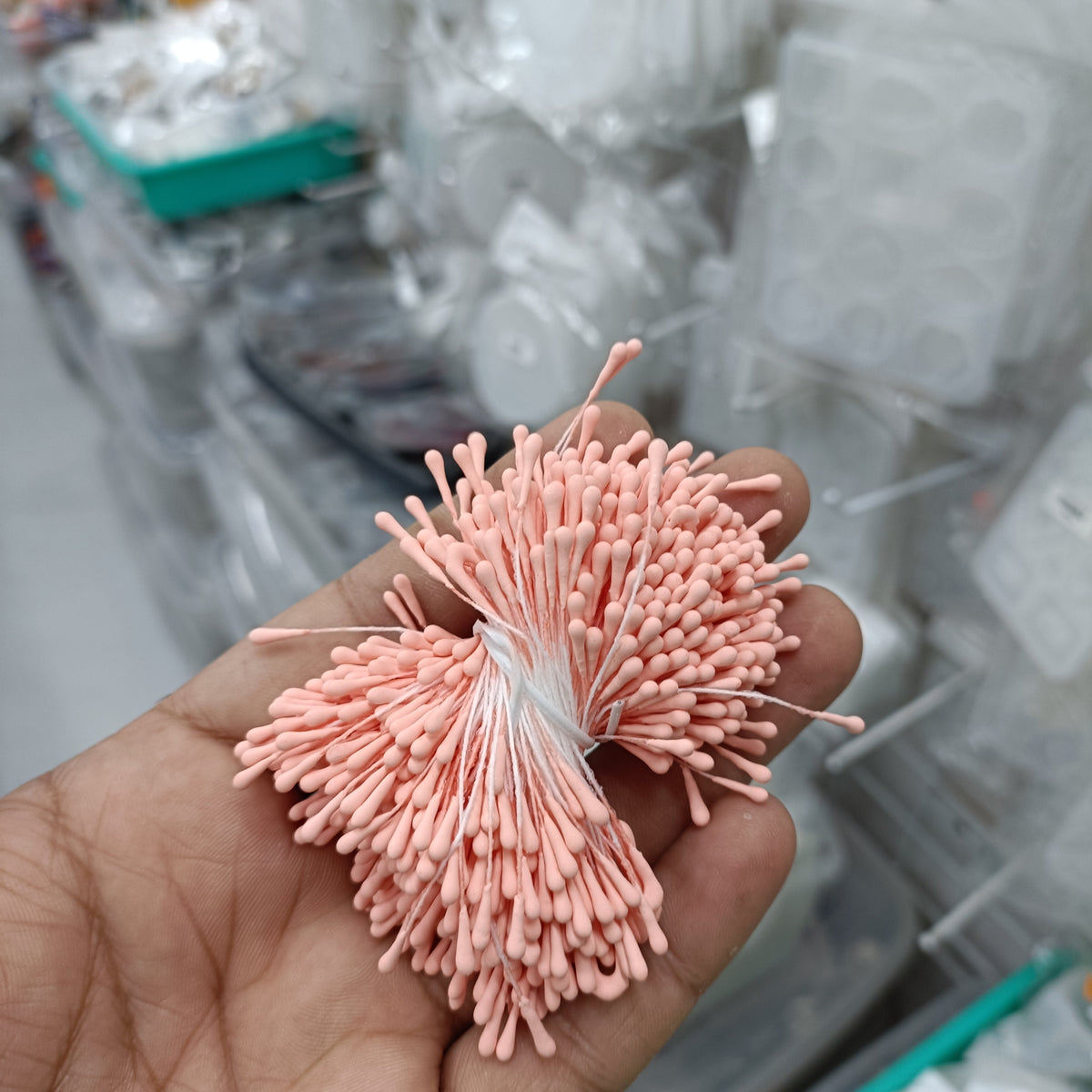 Artificial pollen bunch with soft pink fuzzy florets on slender stems