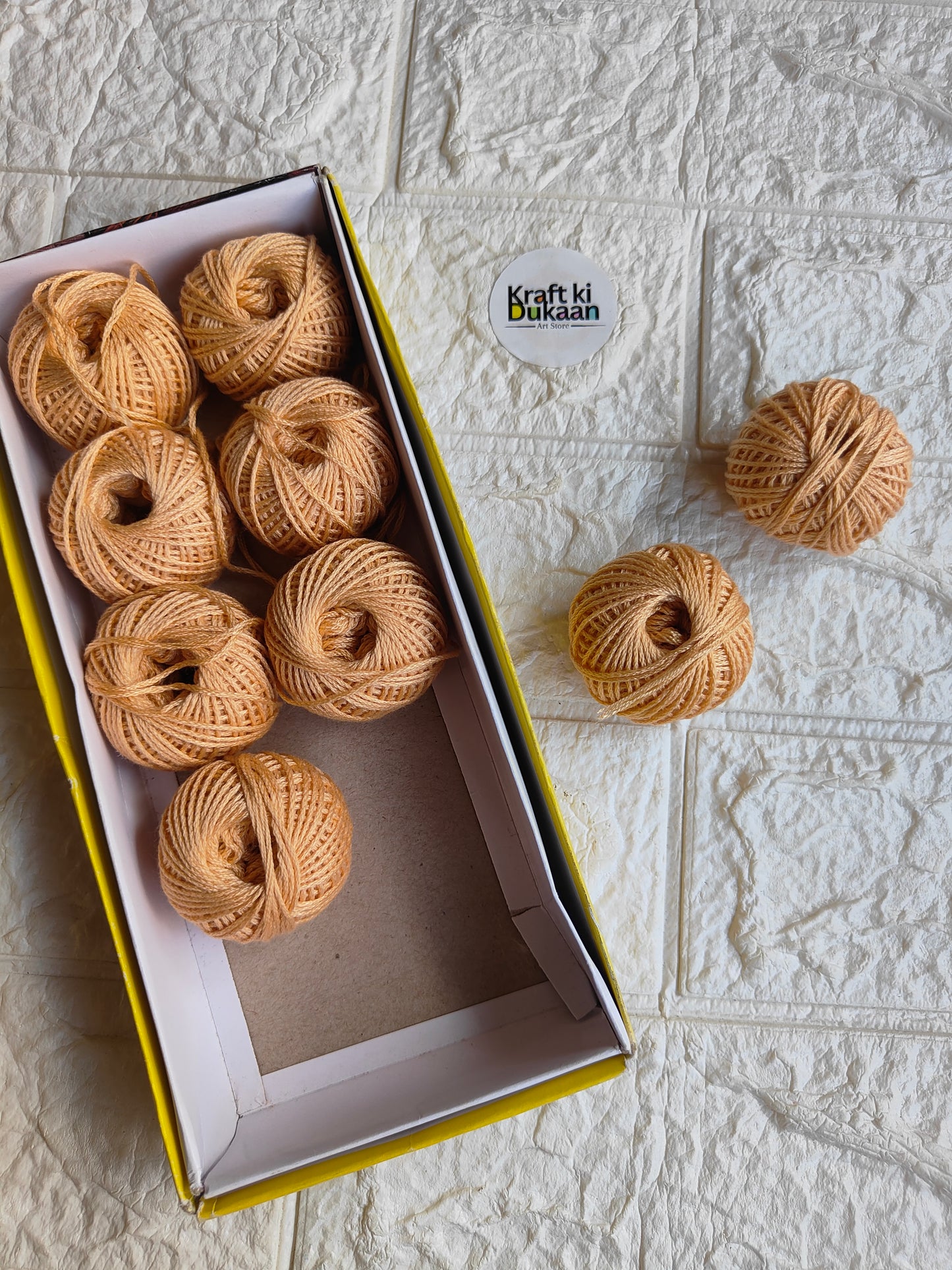 Rakhi thread roll with tan beige thread balls in open box and loose ball