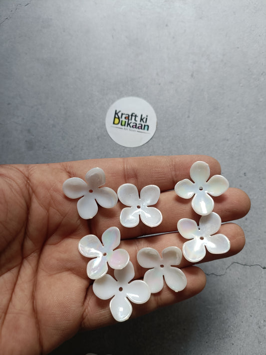 4-kali flower beads, white, 50-pack—on hand holding small flower shapes