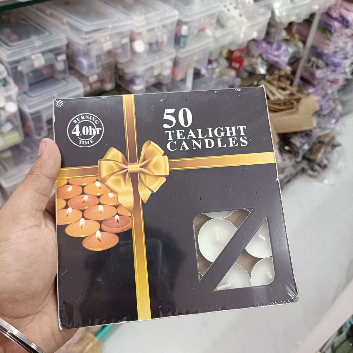 Pack of 50 tealight candles in gift box with gold ribbon and tealight image
