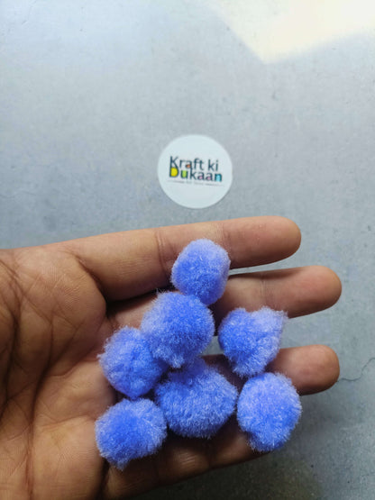 2cm light blue pompom balls held in hand