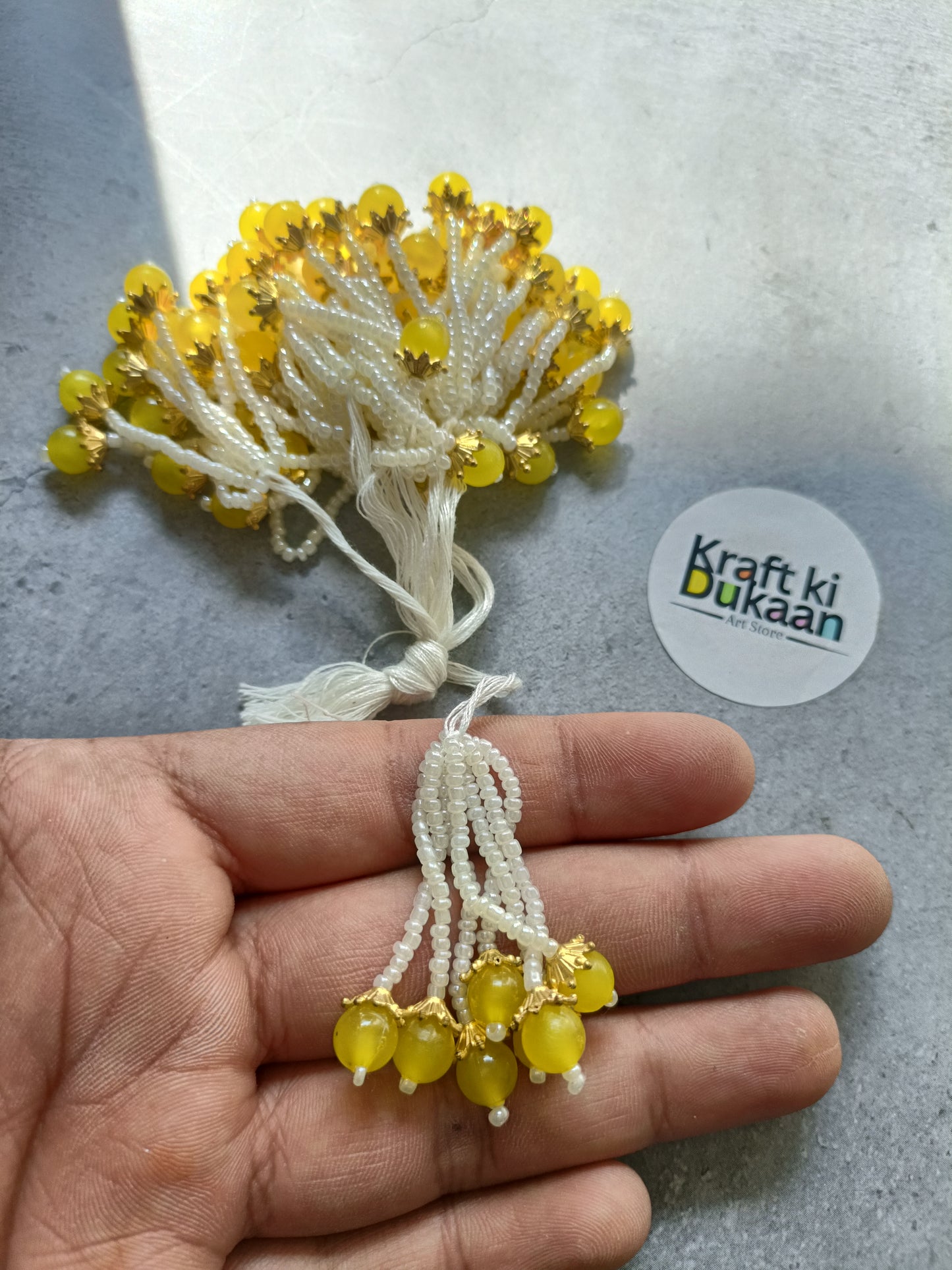 Yellow bead tassel latkan with white thread and gold details
