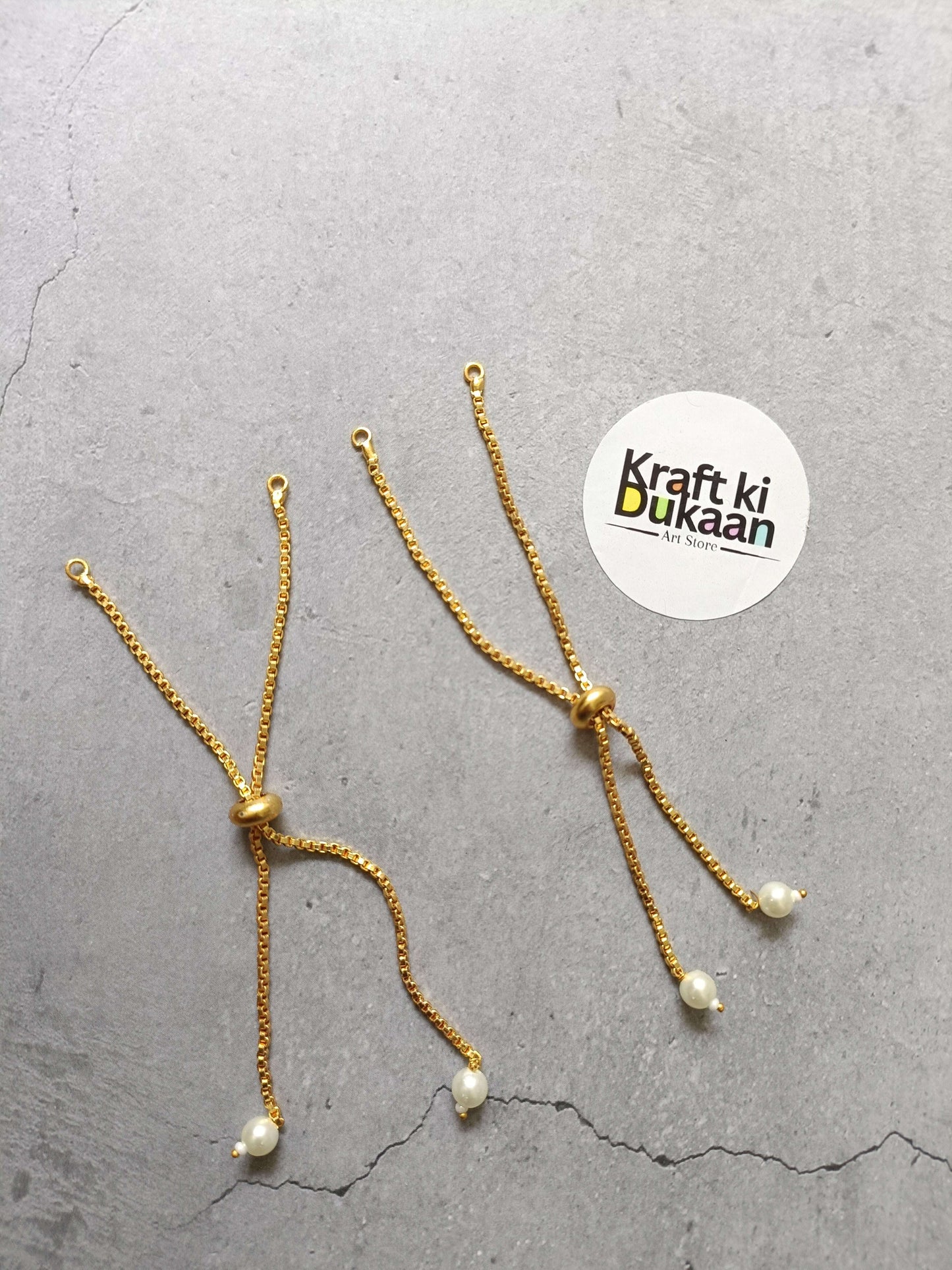 Gold-tone chain bracelet with pearl drop charms and small clasp