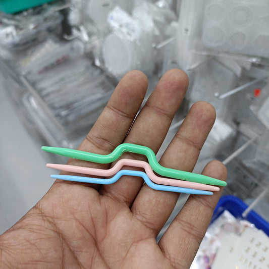 Set of 3 twisted plastic needles with green, purple, and blue handles