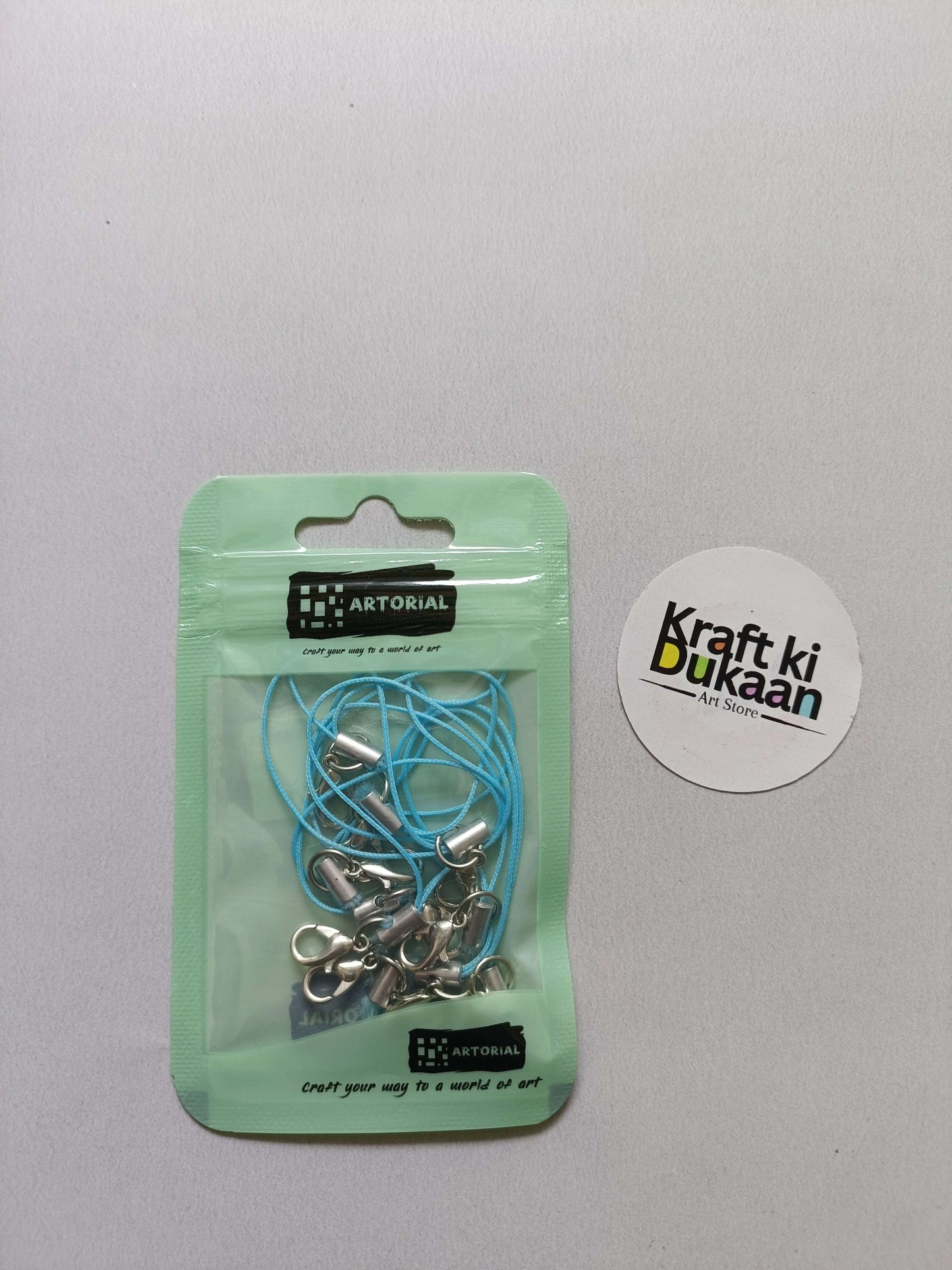 Blue cord keychain set with lobster clasps, metal clips on a card pack.