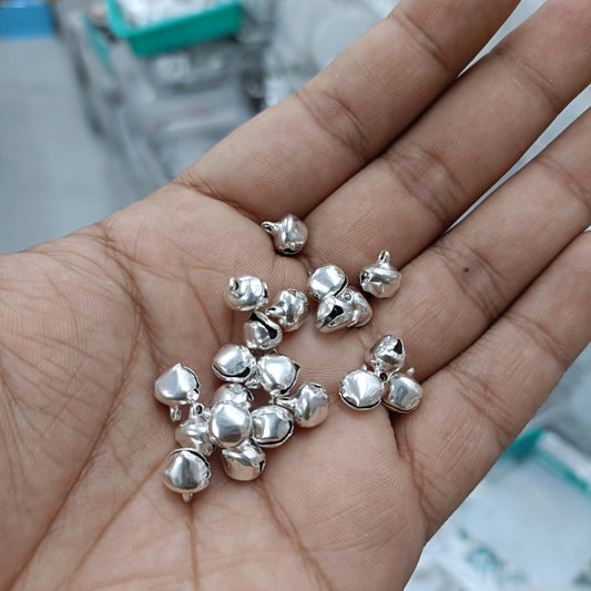 Silver ghunghroo bell charms, small metal bead clusters in a pack