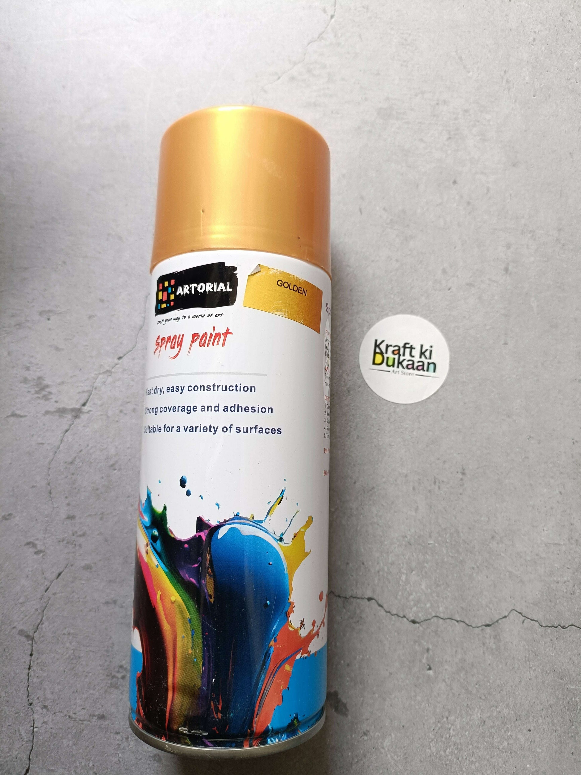 Golden spray paint can with “GOLDEN” label and “Kraft ki Dukaan” sticker